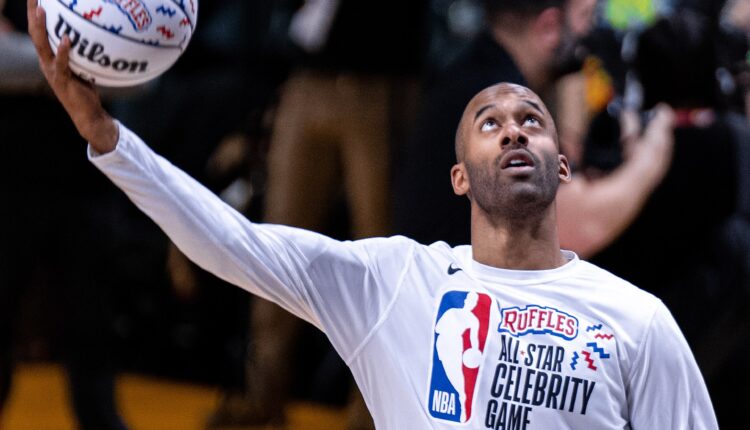 Photo of Matt James in a white t-shirt holding a basketball.