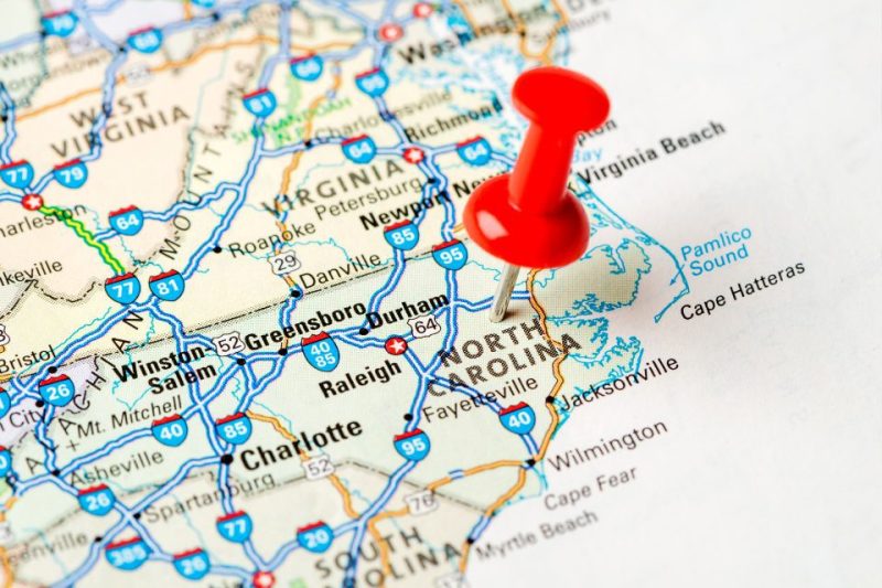 A map of North Carolina with a pin in it.