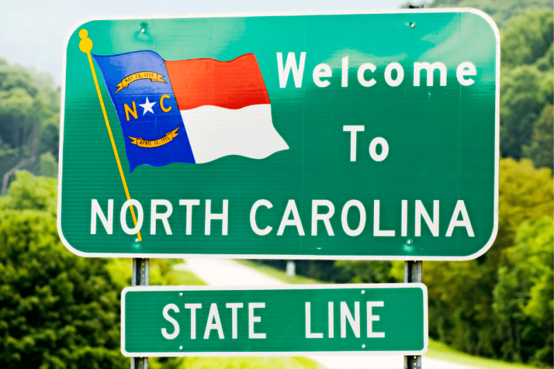 A Welcome to North Carolina state line road sign.