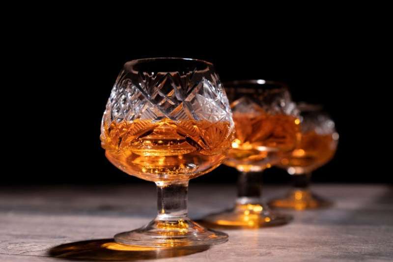 Three bourbon snifters filled with fine bourbon.
