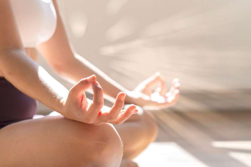 A woman sitting in a yoga post.