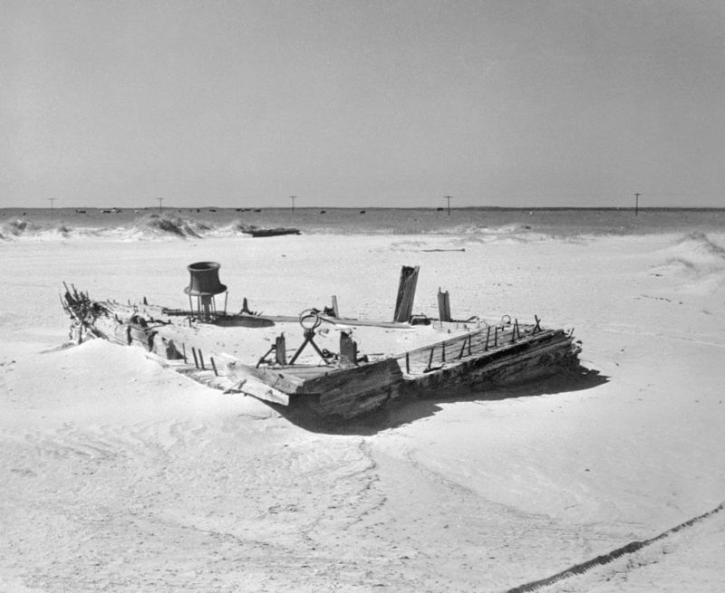 (Original Caption) 7/26/1945- Here is the wreckage of the ghost ship, the Carroll A. Deering, out of Bath, Maine. The ship was found on Diamond Shoals in 1921, undamaged, with sails set, with uneaten food on the table and on the stove, and with only a cat to greet the Coast Guard crew which boarded her. The ship had hailed the Diamond Lightship the day before and that was the last seen of her crew.