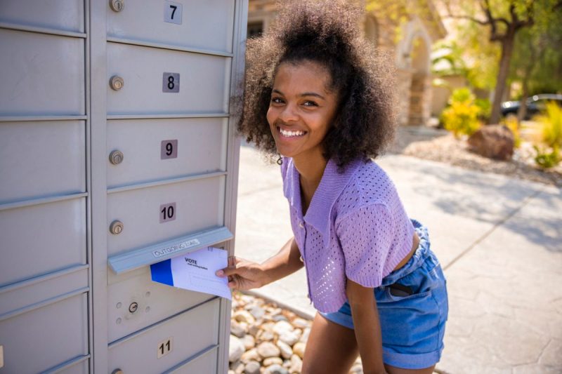 Woman mailing in her ballot