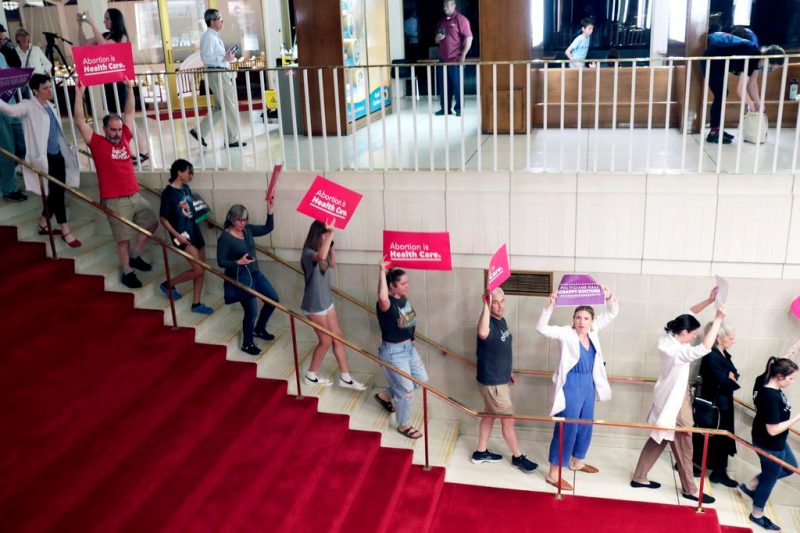 Photo of pro-abortion protesters walking down stairs of the NC General Assembly.