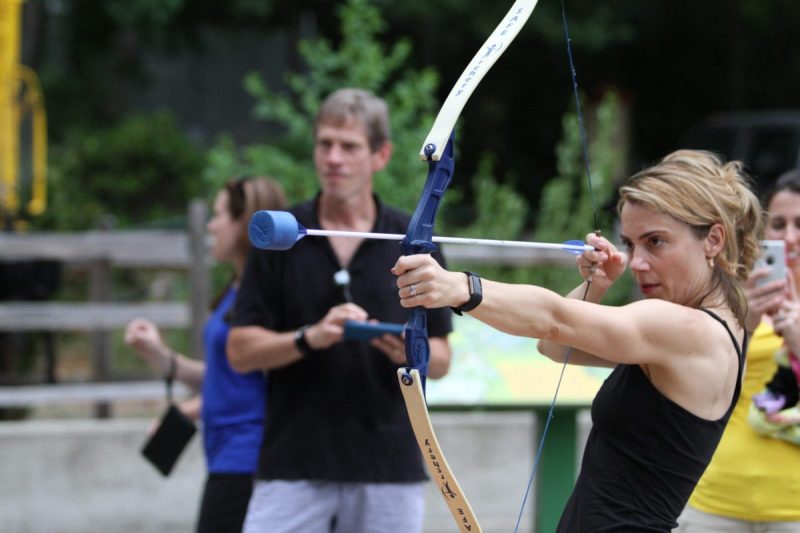 Female archer prepares to shoot her bow