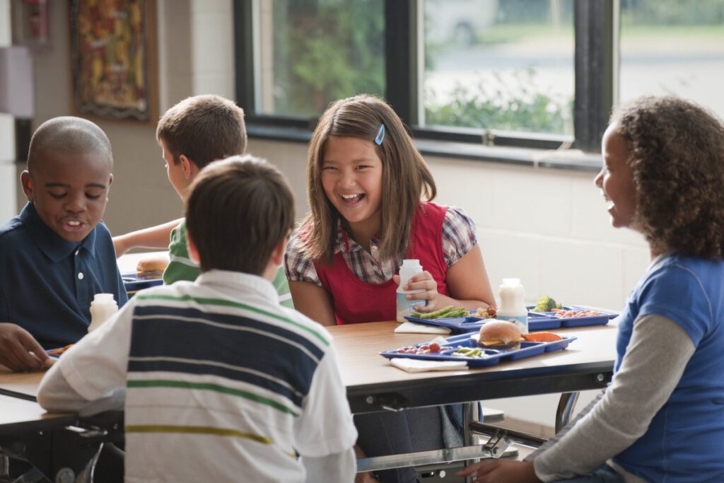kids having lunch together in a school cafeteria