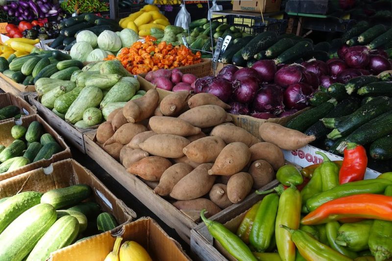Fresh fruits and vegetables laid out on a table at a farmer's market