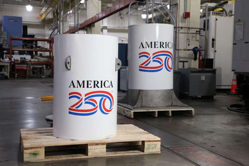 The America250 time capsule, left, and the bell jar that will fit on top of it
